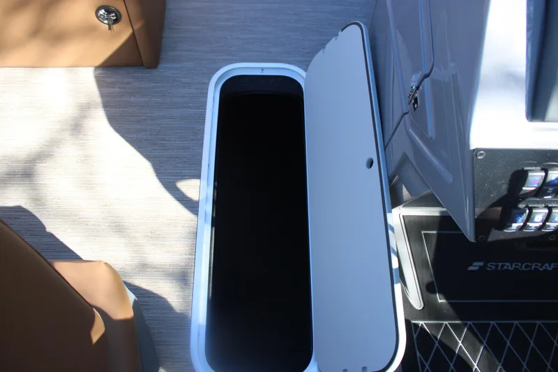 Slide: The Image of Open storage compartment on 2026 Starcraft SLS 3 RL boat, featuring sleek interior design. - 21
