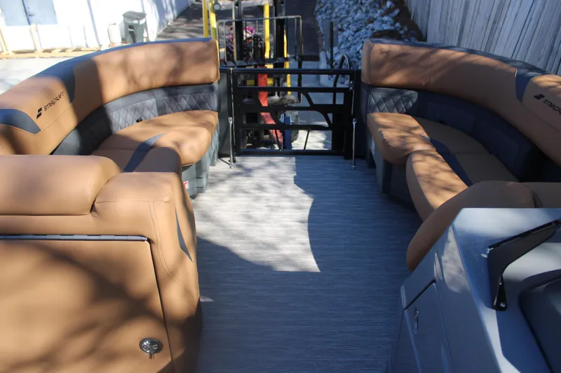 Slide: The Image of 2026 Starcraft SLS 3 RL boat interior with tan seating and modern design. - 24