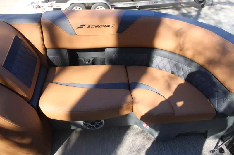 Slide: The Image of Luxurious seating on 2026 Starcraft SLS 3 RL boat, featuring tan and black upholstery. - 25