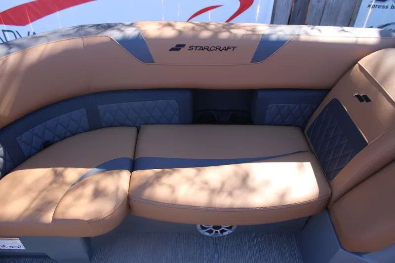 Slide: The Image of 2026 Starcraft SLS 3 RL boat interior with tan and gray cushioned seating. - 26