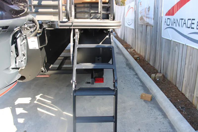 Slide: The Image of Staircase of 2026 Starcraft SLS 3 RL boat, parked on concrete surface. - 6