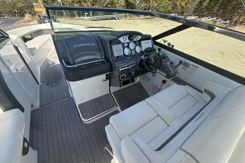 Slide: The Image of 2015 Formula 350 Crossover Bowrider cockpit with steering wheel and control panel. - 13