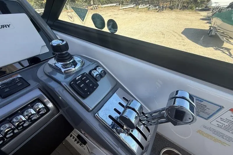 Slide: The Image of Control panel of a 2015 Formula 350 Crossover Bowrider boat with throttle levers. - 14