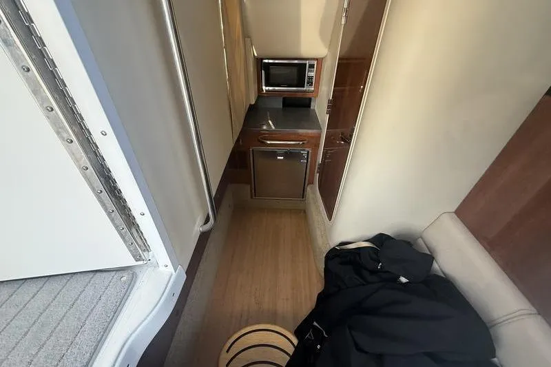 Slide: The Image of Interior of 2015 Formula 350 Crossover Bowrider with kitchenette and seating area. - 15
