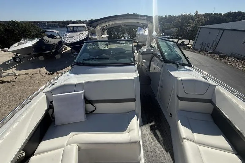 Slide: The Image of 2015 Formula 350 Crossover Bowrider with spacious seating and sleek design in a marina setting. - 21