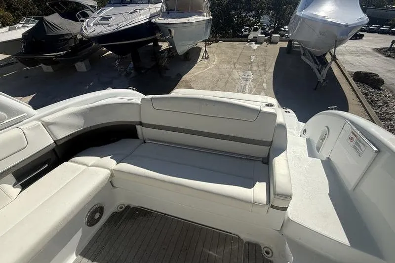 Slide: The Image of 2015 Formula 350 Crossover Bowrider interior with white seating, docked among other boats. - 24