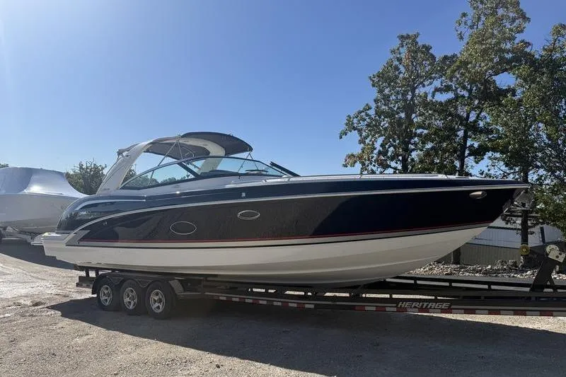 Slide: The Image of 2015 Formula 350 Crossover Bowrider on trailer, parked outdoors, sunny day. - 5