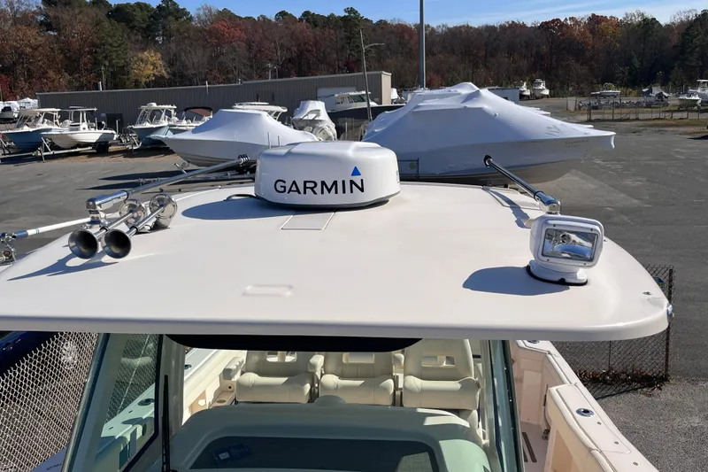 Slide: The Image of 2022 Grady-White Canyon 336 boat with Garmin radar and spotlight on deck. - 13
