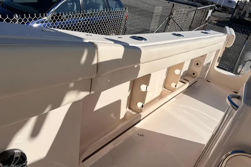 Slide: The Image of 2022 Grady-White Canyon 336 boat interior with rod holders and seating. - 14