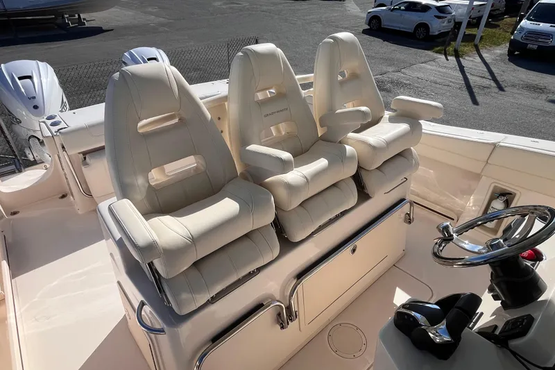 Slide: The Image of 2022 Grady-White Canyon 336 boat with three luxurious helm seats and steering wheel. - 6