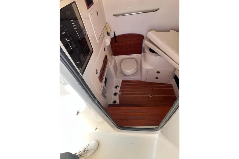Slide: The Image of 2022 Grady-White Canyon 336 boat interior with toilet and wooden flooring. - 8
