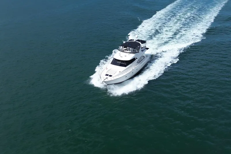 The Image of 2005 Meridian 580 Pilothouse yacht cruising on open water. - 0