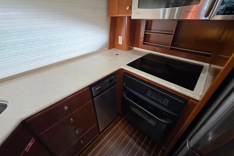 Slide: The Image of Luxurious kitchen in 2005 Meridian 580 Pilothouse yacht with modern appliances and sleek countertops. - 16