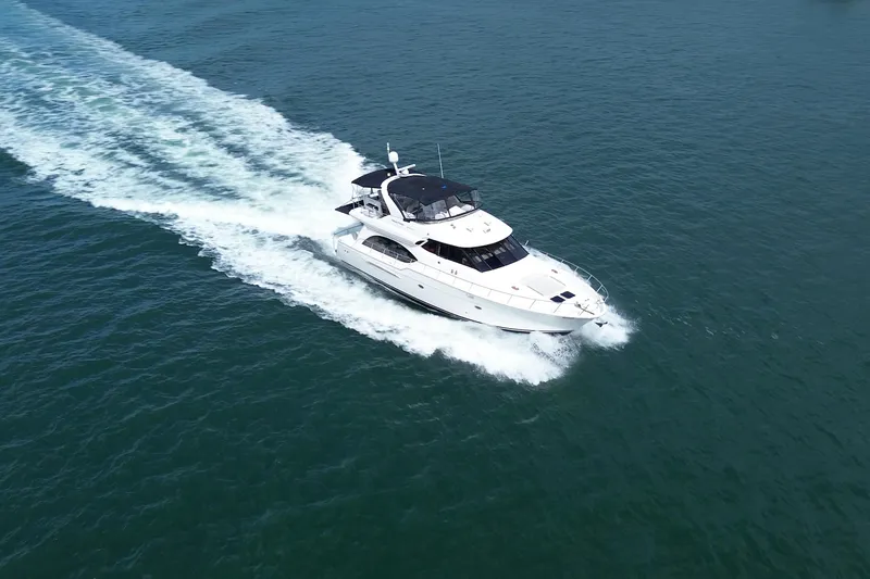 Slide: The Image of 2005 Meridian 580 Pilothouse yacht cruising on open water. - 2