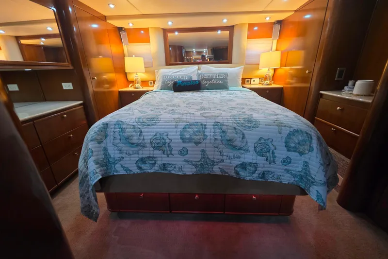 Slide: The Image of Luxurious bedroom interior of 2005 Meridian 580 Pilothouse yacht with elegant bedding and warm lighting. - 26