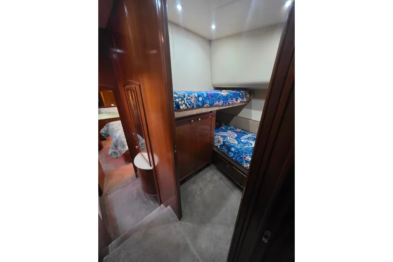 Slide: The Image of 2005 Meridian 580 Pilothouse interior with bathroom, wooden cabinetry, and bunk beds. - 39