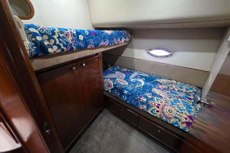 Slide: The Image of 2005 Meridian 580 Pilothouse interior with cozy bunk beds and elegant wood finish. - 40