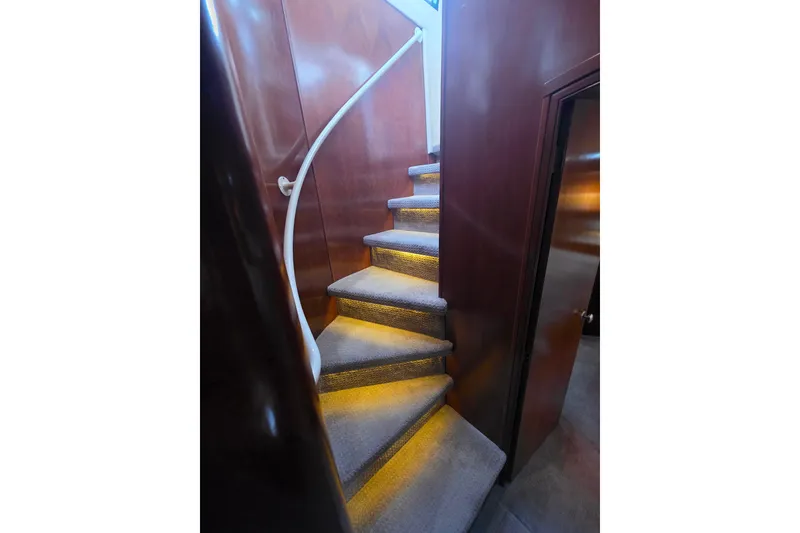 Slide: The Image of Interior of 2005 Meridian 580 Pilothouse yacht with wooden finishes and carpeted stairs. - 43