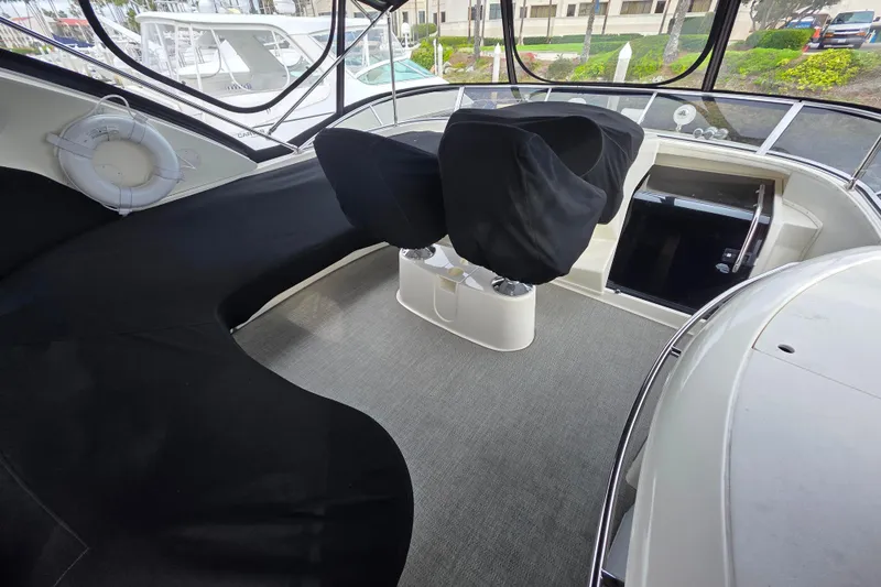 Slide: The Image of 2005 Meridian 580 Pilothouse interior with seating and helm, showcasing luxury yacht design. - 45