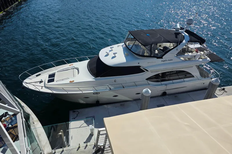 Slide: The Image of 2005 Meridian 580 Pilothouse yacht docked at marina, sunny day, calm water. - 5