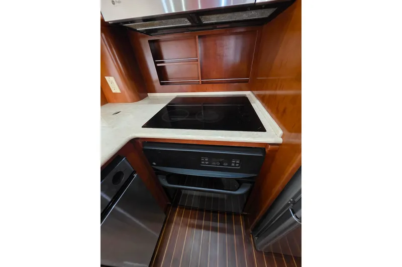 Slide: The Image of 2005 Meridian 580 Pilothouse interior with helm, seating, and navigation equipment. - 59