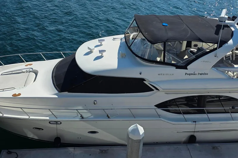 Slide: The Image of 2005 Meridian 580 Pilothouse yacht docked at marina, sunny day. - 6