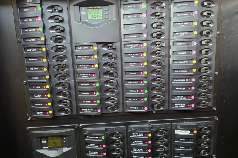 Slide: The Image of Electrical panel of a 2005 Meridian 580 Pilothouse yacht with various switches and gauges. - 72