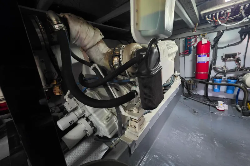 Slide: The Image of Engine room of a 2005 Meridian 580 Pilothouse yacht, showcasing machinery and equipment. - 76