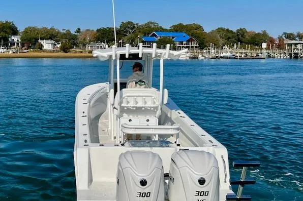 Slide: The Image of 2026 Pair Customs 28 Center Console boat on calm water, featuring dual 300 horsepower engines. - 3