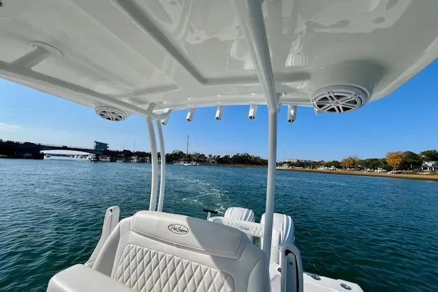 Slide: The Image of 2026 Pair Customs 28 Center Console boat on a scenic waterway. - 6