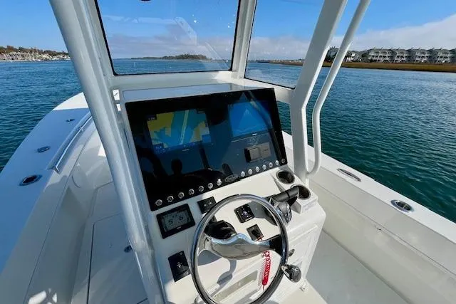 Slide: The Image of 2026 Pair Customs 28 Center Console boat with modern navigation system on open water. - 7