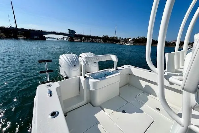 Slide: The Image of 2026 Pair Customs 28 Center Console boat on water near a bridge. - 8