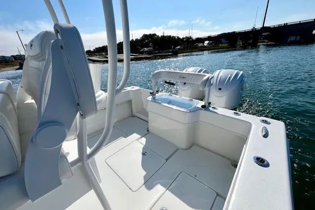 Slide: The Image of 2026 Pair Customs 28 Center Console boat on water, showcasing sleek design and dual engines. - 9