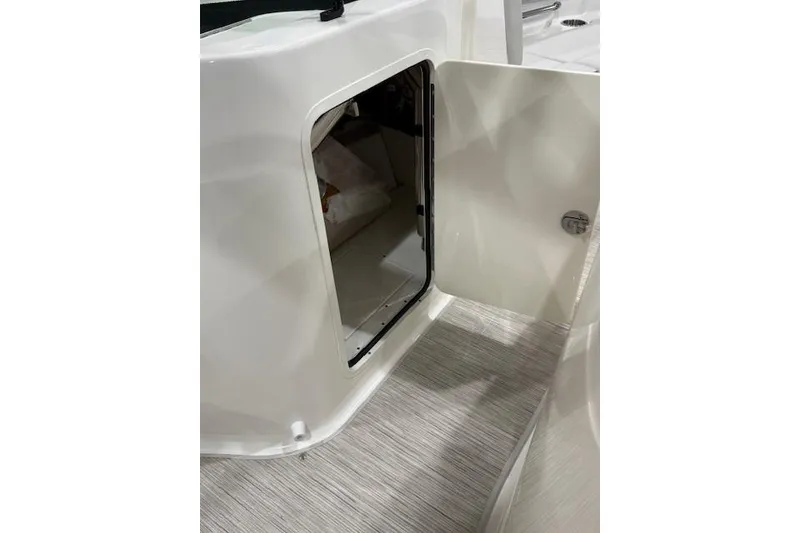 Slide: The Image of 2026 Sea Ray SDX 230 boat with spacious seating and sleek design. - 12