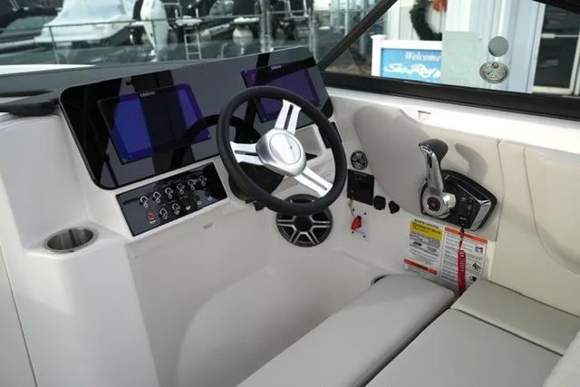 Slide: The Image of 2026 Sea Ray SDX 230 boat cockpit with modern steering and control panel. - 14