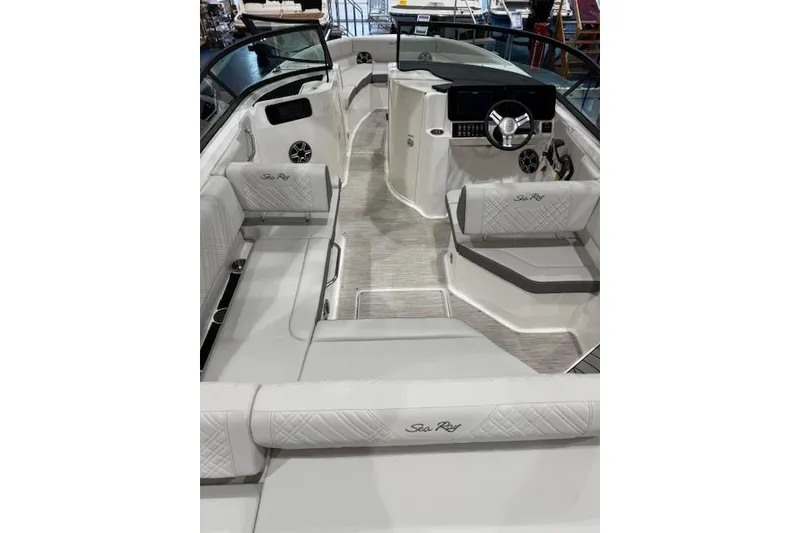 Slide: The Image of 2026 Sea Ray SDX 230 boat on trailer, blue and white design, parked outdoors. - 4