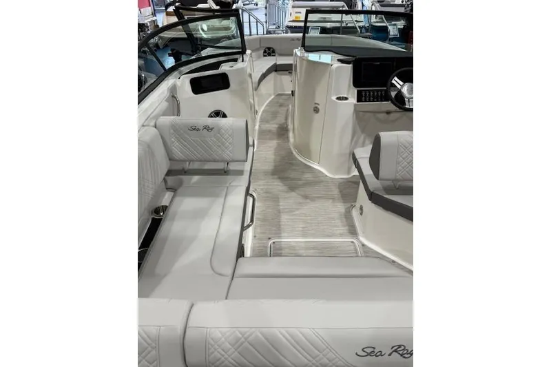 Slide: The Image of 2026 Sea Ray SDX 230 boat on trailer, blue and white design, parked outdoors. - 5