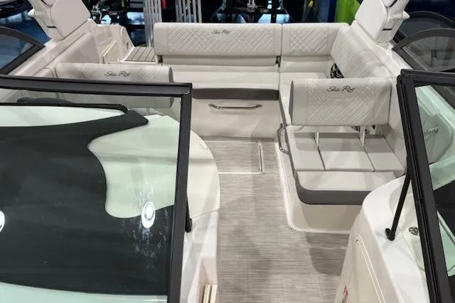 Slide: The Image of 2026 Sea Ray SDX 230 boat with blue hull on trailer, parked outside dealership. - 7