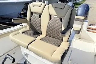 Slide: The Image of 2021 Tidewater 272 CC Adventure boat seats with beige and brown upholstery. - 10