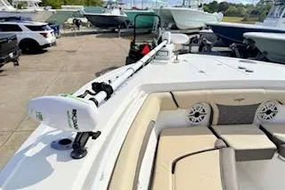 Slide: The Image of 2021 Tidewater 272 CC Adventure boat with trolling motor and seating, docked outdoors. - 16