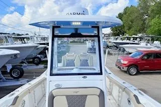 Slide: The Image of 2021 Tidewater 272 CC Adventure boat with Garmin equipment, parked in a marina. - 18
