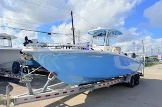 Slide: The Image of 2021 Tidewater 272 CC Adventure boat on trailer under blue sky. - 3