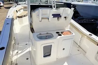 Slide: The Image of 2021 Tidewater 272 CC Adventure boat interior with sink and storage compartments. - 5