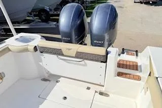 Slide: The Image of 2021 Tidewater 272 CC Adventure boat with dual engines and rear seating area. - 7