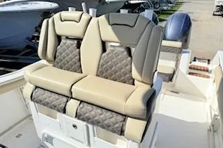 Slide: The Image of 2021 Tidewater 272 CC Adventure boat with cushioned seating and storage compartments. - 9