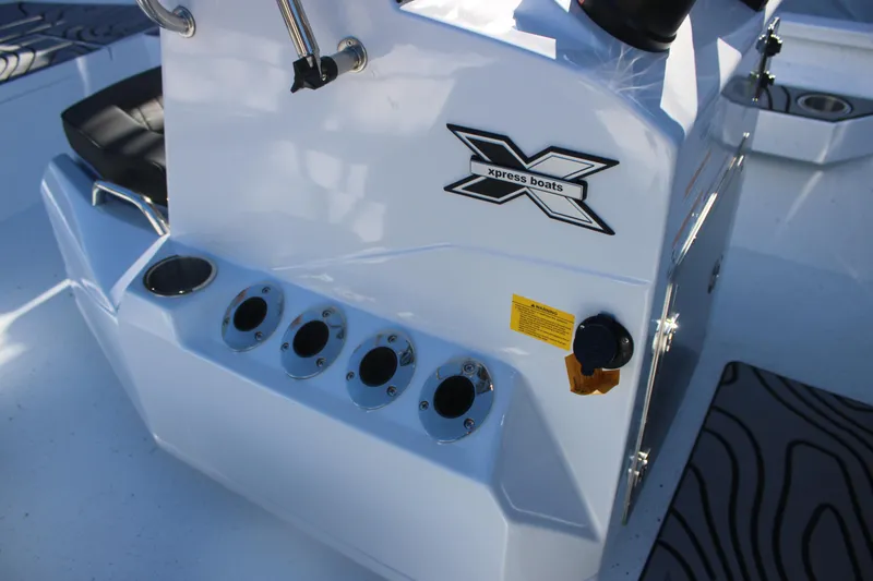 Slide: The Image of 2026 Xpress H20B Bay boat console with rod holders and logo. - 14
