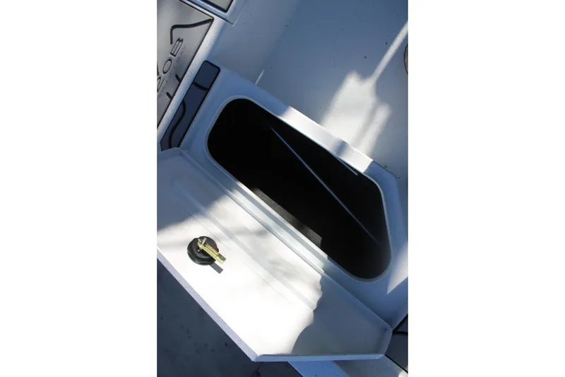 Slide: The Image of Open storage compartment on 2026 Xpress H20B Bay boat, featuring a secure latch. - 25