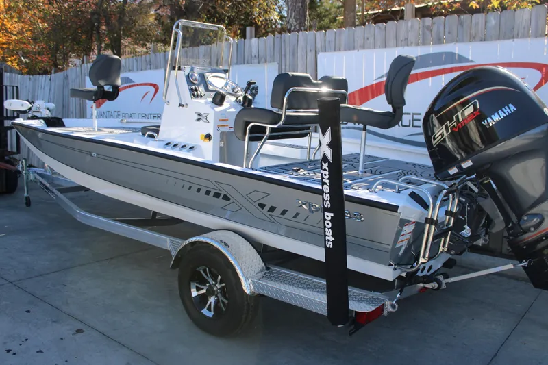 Slide: The Image of 2026 Xpress H20B Bay boat with Yamaha engine on trailer, displayed outdoors. - 3