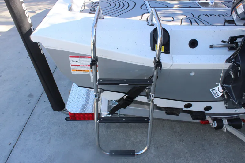 Slide: The Image of 2026 Xpress H20B Bay boat with rear ladder and safety warnings. - 6