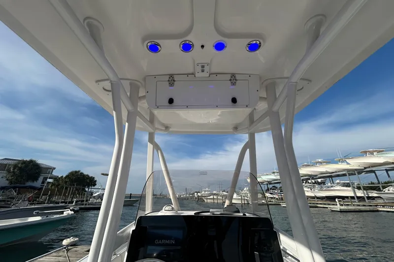Slide: The Image of 2025 Sea Hunt Ultra 229 boat interior with blue LED lights and Garmin navigation. - 18